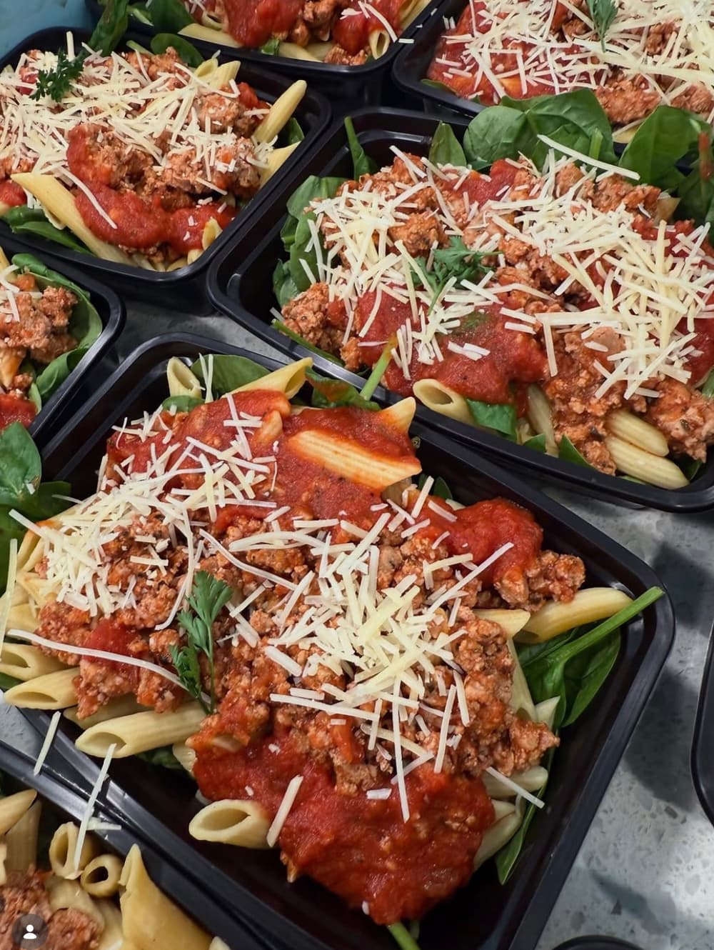 Turkey penne in red sauce with parmesan in prep containers